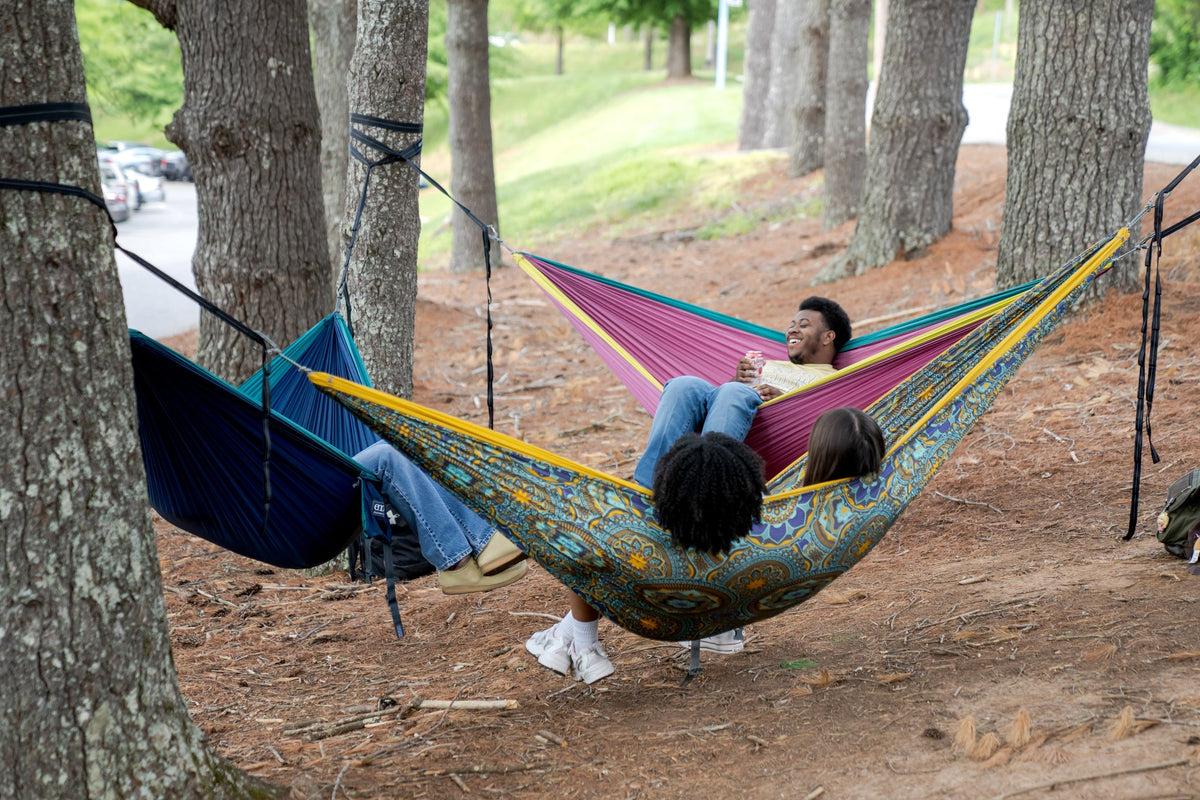A group of 4 friends hammocking in 3 ENO DoubleNest Hammocks