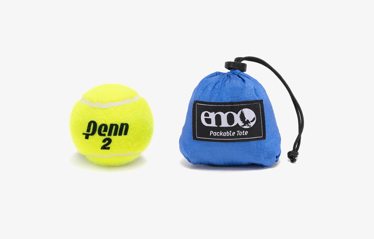 Packed up Packable Tote in its stuff sack compared to tennis ball in size