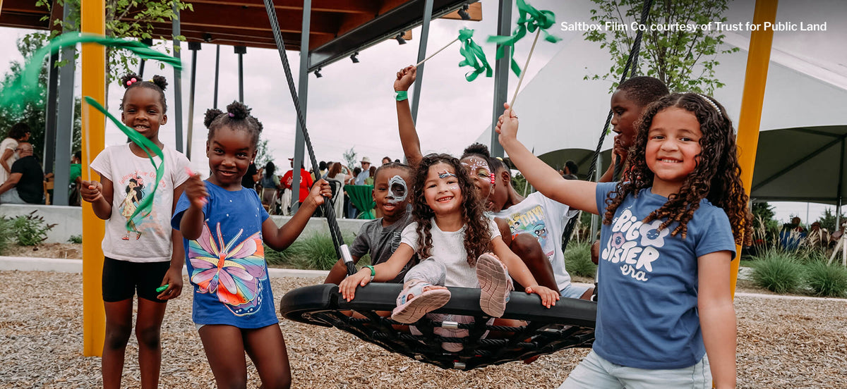 Children playing on a playground with colorful equipment