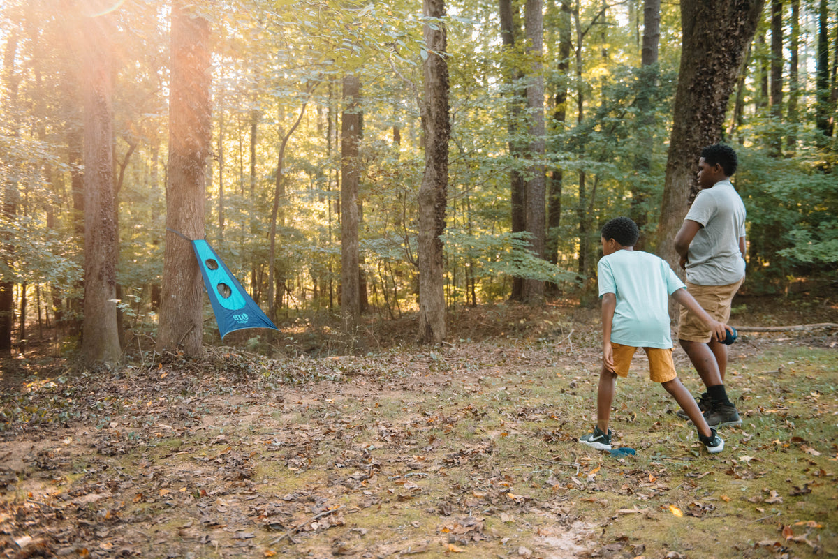 Two boys playing with the ENO TrailFlyer Outdoor Game outside