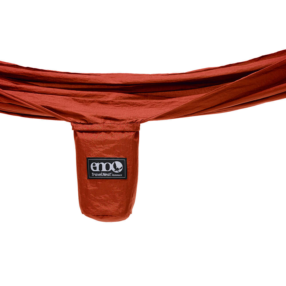Detail studio image of the TravelNest Hammock + Straps Combo unpacked stuff sack hanging in front of white backdrop.