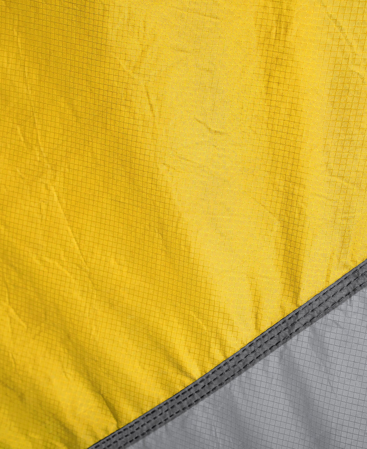 Close-up of yellow and gray fabric with a grid pattern